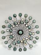 A cast metal circular radiating wall applique with circular mother of peal and abalone panels (d-