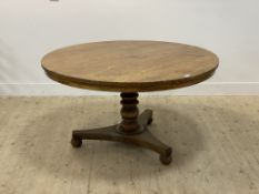 A late Regency walnut breakfast or centre table, the circular tilt top (lacking pins) raised on a