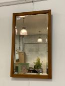 A varnished pine framed wall mirror with bevelled plate 42cm x 67cm