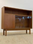McIntosh, a mid century teak bookcase, with open shelf above two sliding glazed doors enclosing an
