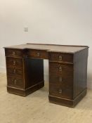 A Victorian oak desk, the inverted break front, cross banded and acanthus carved top above three