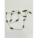 A green Chalcedony tapered barrel mounted long gilt chain necklace, (L x 65cm approximately)