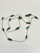 A green Chalcedony tapered barrel mounted long gilt chain necklace, (L x 65cm approximately)