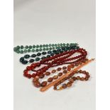 A group of six necklaces including two graduated green stone bead necklaces, (L x 22cm) a red