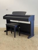 A Broadway digital piano in a walnut effect case, (H85cm, W140cm, D43cm) complete with a music