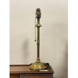 An early 20th century cast brass table lamp, the reeded post formed as a fasces on a acanthus