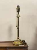 An early 20th century cast brass table lamp, the reeded post formed as a fasces on a acanthus