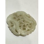 A Chinese pierced pale celadon jadite carved panel with twin standing dragons figures, (L x 6cm)