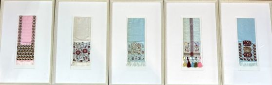 A collection of five Eastern silk samples with tassels in a cream painted glazed frame. (