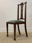 A reproduction side chair, carved crest rail, splat back, drop in seat pad, raised on square tapered