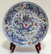 A large modern Chinese polychrome porcelain charger with central roundel depicting five-claw