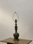 A cast brass table lamp base of faceted baluster form, in the Oriental style, with faux verdigris