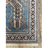 A Turkish rug, the blue field with star medallion and geometric design and bordered 320cm x 201cm