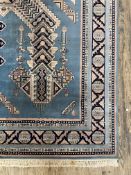 A Turkish rug, the blue field with star medallion and geometric design and bordered 320cm x 201cm