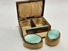A Birmingham silver celadon green guilloche enamel three piece child's hair brush set comprising a