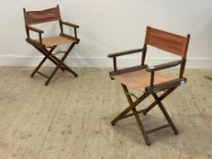 A pair of vintage teak framed directors type folidng chairs with slung canvas seat and back rest,