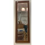 A pine framed wall mirror with beveled plate 43cm x 127cm