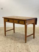 A Victorian varnished pine kitchen prep table, the top with drop leaf to back above two drawers,
