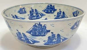 A large blue and white crackle glazed bowl decorated with sailboats and ships (h- 15cm, w- 36cm)