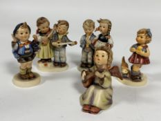 A collection of five German Hummel pottery figures including, Home from Market, Birthday Serenade,