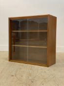 A mid century teak glazed bookcase fitted with two shelves, H69cm, W69cm, D28cm