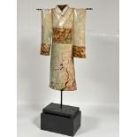 A modern Japanese cast metal Kimono sculpture decorated with enamel cherry blossom design on black