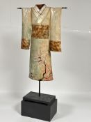 A modern Japanese cast metal Kimono sculpture decorated with enamel cherry blossom design on black