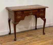A George III oak lowboy, the mahogany cross banded top with herringbone inlay and moulded edge above
