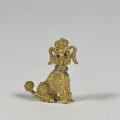 A diamond and ruby-set gold brooch modelled as a seated poodle, with ruby eyes and diamond-set