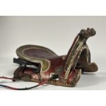 A rare Persian painted wooden saddle, late 18th/19th century, of characteristic form, polychrome