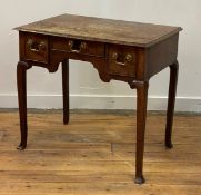 A George III oak lowboy, the cross banded top with moulded edge above one long and two short drawers