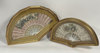 Two 19th century painted French fans, each mounted in a glazed giltwood case: the first with gilt-