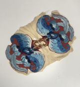 A pair of Chinese embroidered silk badges, each worked in coloured and gilt threads as a bat,