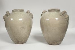 A pair of large Chinese celadon crackle glazed pottery jars, of moulded construction and each with
