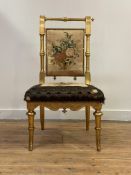 A Victorian giltwood occasional chair, with ring turned crest rail and posts enclosing a back rest