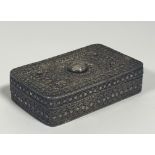 A white metal filigree box, possibly Indo-Persian, of oblong form, the hinged cover, base and