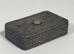 A white metal filigree box, possibly Indo-Persian, of oblong form, the hinged cover, base and