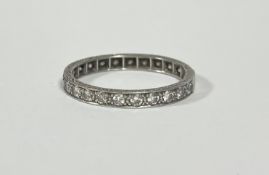 A full hoop diamond eternity ring, the twenty-two round brilliant-cut stones millegrain set in white