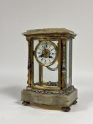 A French onyx and champleve enamel mantel clock, late 19th century, the bowed oblong case with