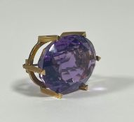 A 9ct gold amethyst brooch, late 19th century, the large oval-cut stone claw-set in yellow gold,