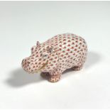 A Herend porcelain model of a smiling hippopotamus, in coral, printed mark. Length 11.5cm