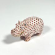 A Herend porcelain model of a smiling hippopotamus, in coral, printed mark. Length 11.5cm