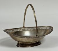 A George III silver swing-handled basket, William Plummer, London 1787, of navette form, the