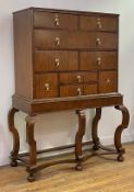 A 1920's walnut chest on stand of George I design, the top with moulded edge above a combination