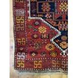 A hand knotted Kurdish runner rug, the red ground with geometric design to pole medallion and