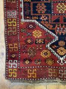 A hand knotted Kurdish runner rug, the red ground with geometric design to pole medallion and