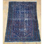 An antique Persian hand knotted rug the blue ground with stylised repeating herati and flowerhead