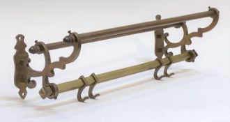 A late 19th to early 20th century cast brass luggage rail with four sliding coat hooks L62cm