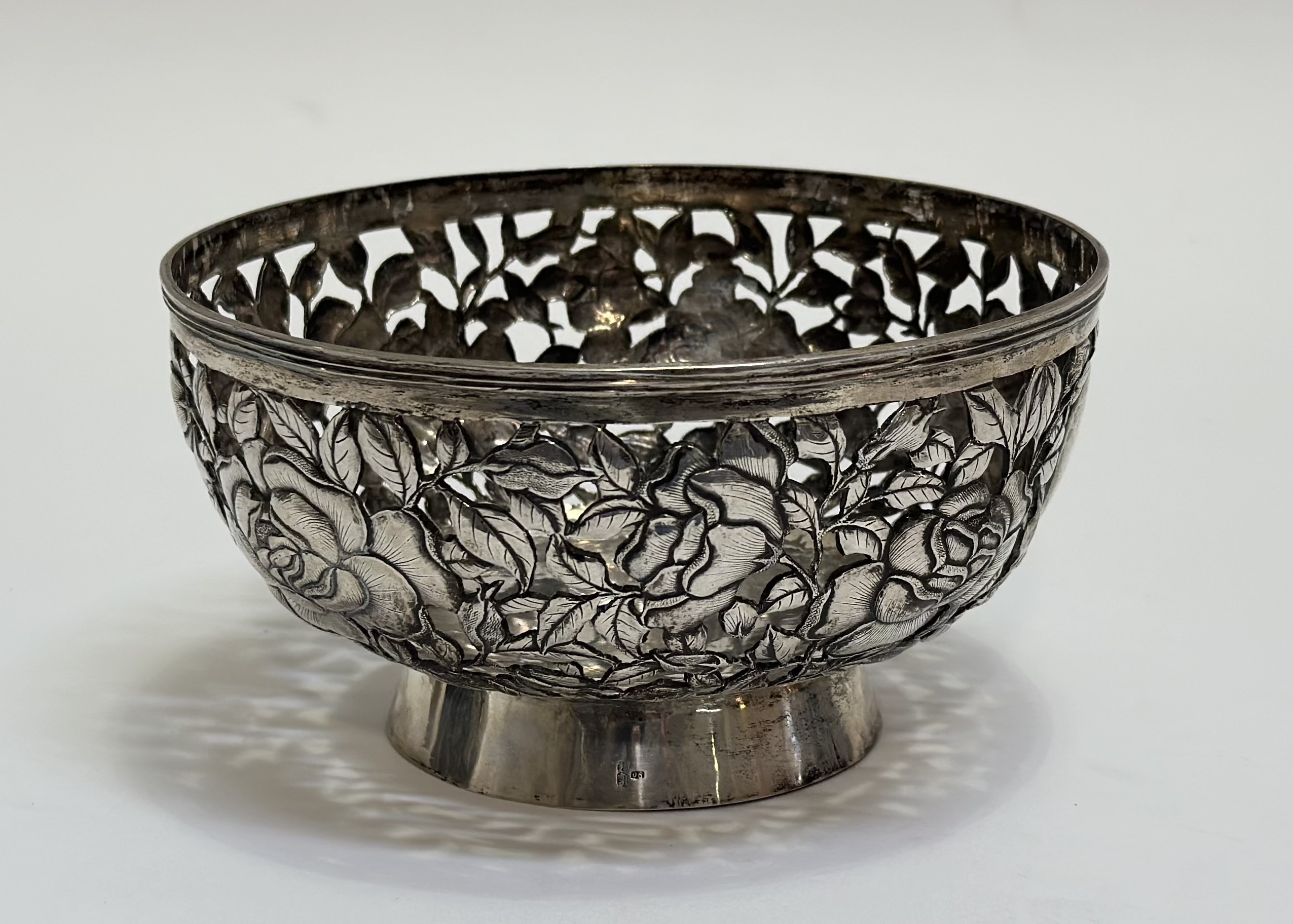 A Chinese Export silver bowl, c. 1900, in the manner of Wang Hing, pierced and chased with roses and