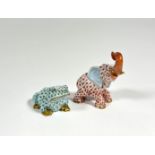 Two Herend porcelain models of animals comprising: an elephant with upraised trunk in coral and a